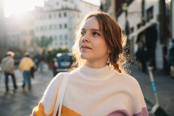 pensive woman looking into sky