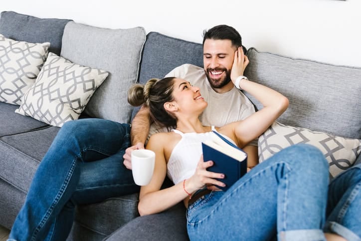 couple cuddling on couch at home