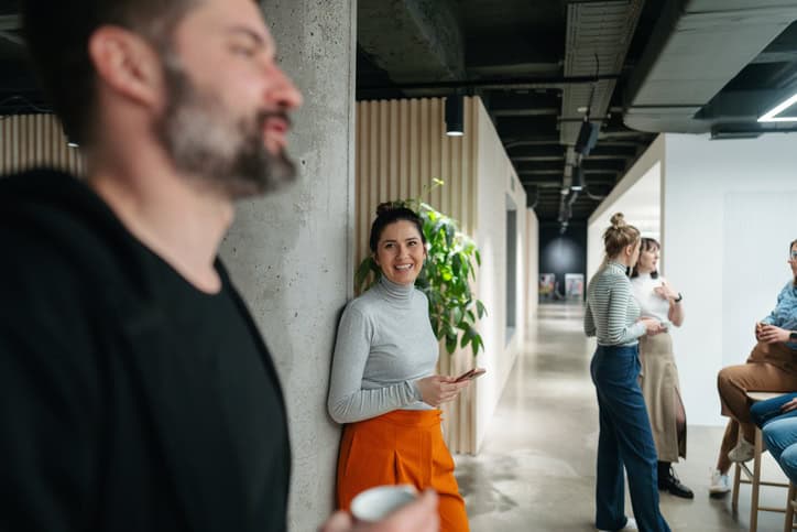 woman smiling at male co-worker