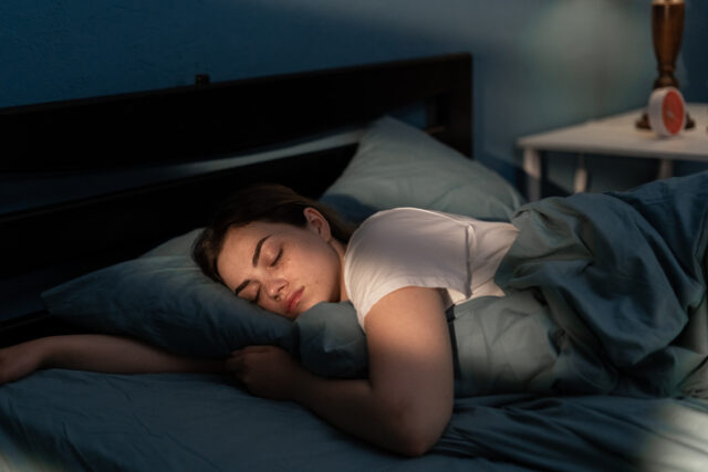 woman asleep and dreaming in bed