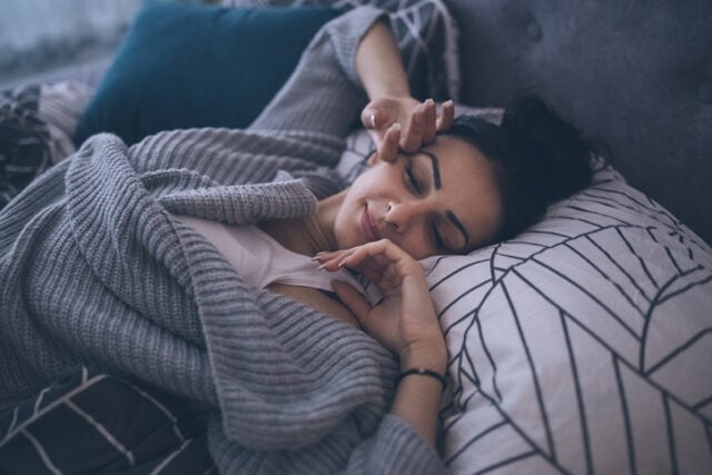 woman having a nap in bed
