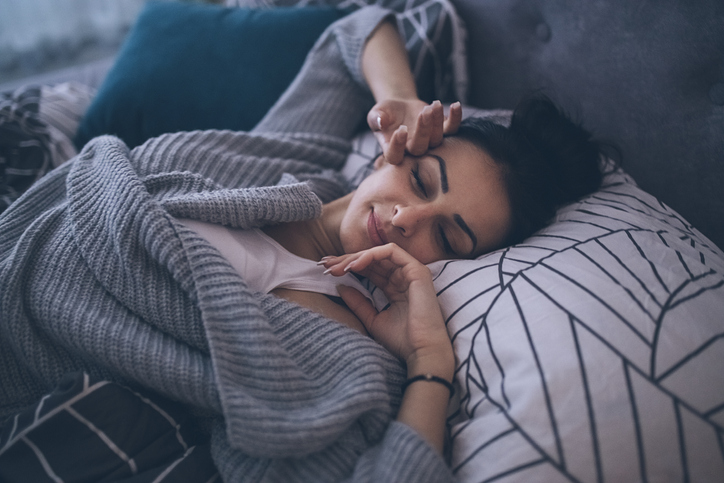 Woman having a nap in bed.