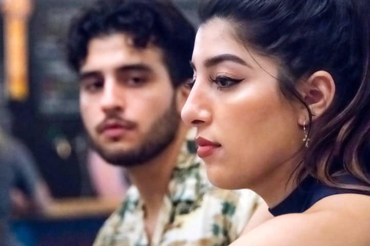 Hispanic young couple flirting at a bar