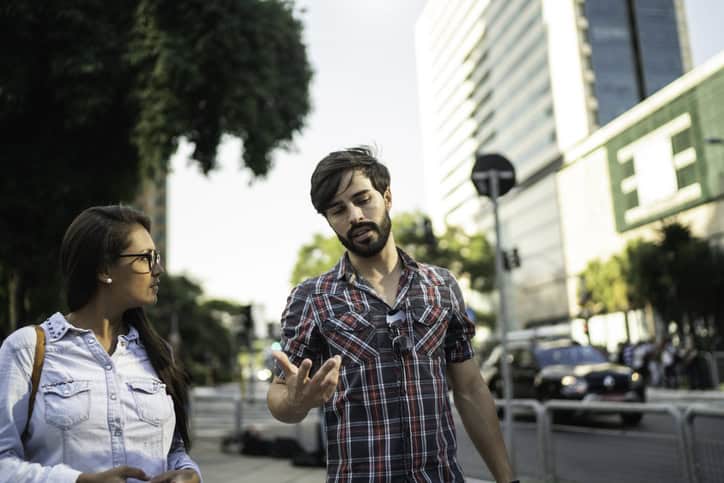 man and woman walking down street
