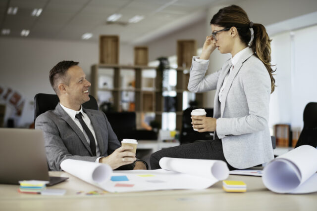 man woman business talking at work