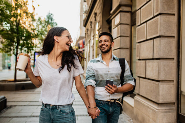 couple holding hands on the street