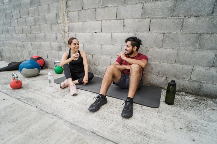 Couple sitting down after workout.