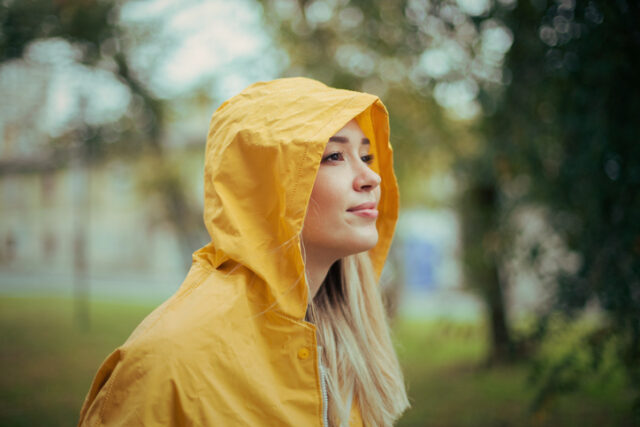 Woman wearing a yellow raincoat.