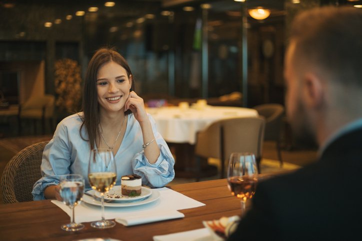 Cheerful man having fun with his girlfriend in a restaurant.