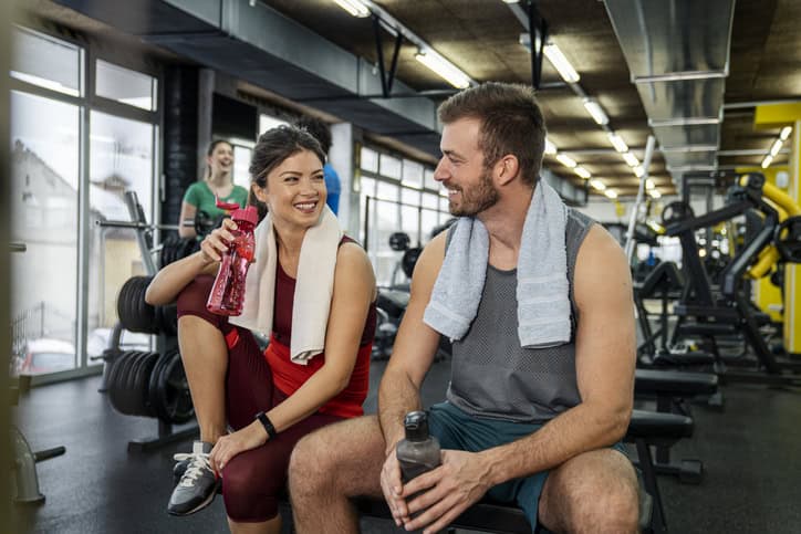 man woman chatting at gym