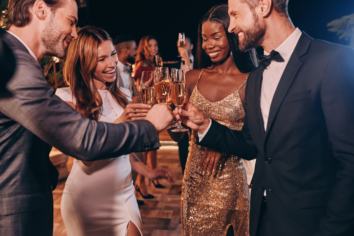 Group of people at a party toasting with champagne.
