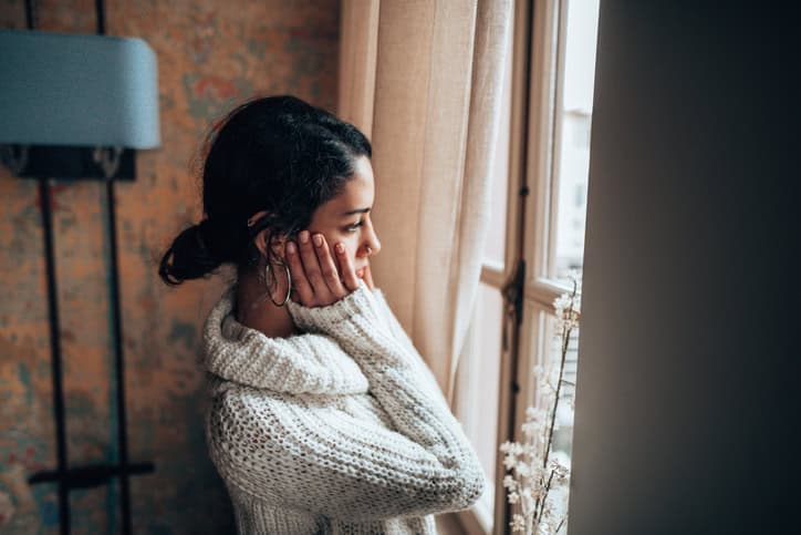 pensive woman looking at the window