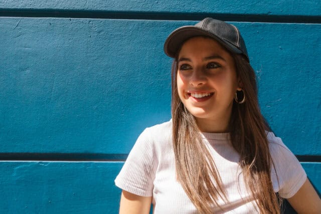 smiling woman in basebal cap sunny day