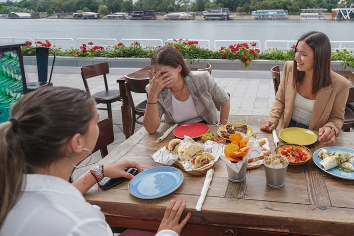 women chatting at outdoor cafe