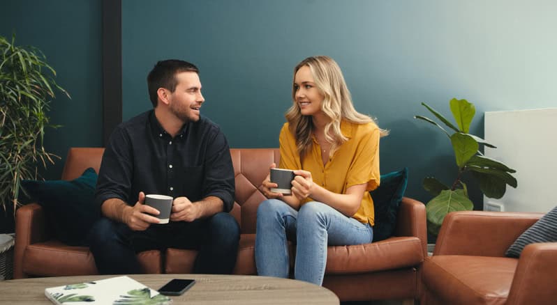 Shot of a happy young couple enjoying a relaxing coffee break on the sofa at home
