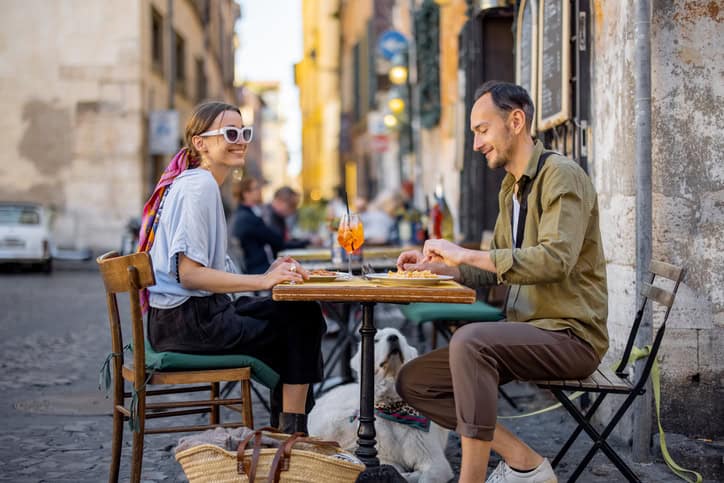 Man and woman eating pasta.