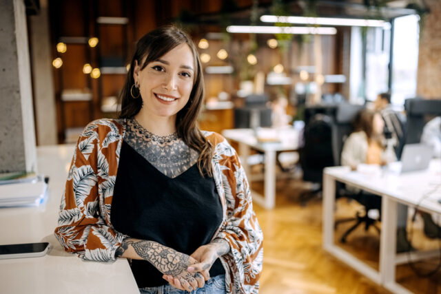 tattooed woman in office