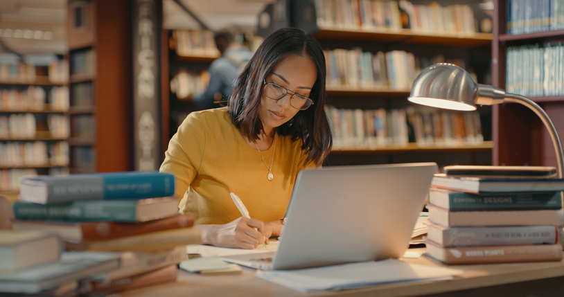Woman on computer sending emails.