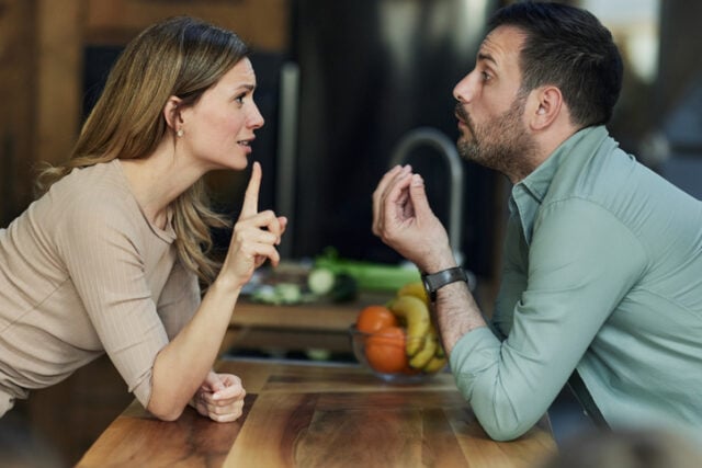 young couple arguing in the kitchen