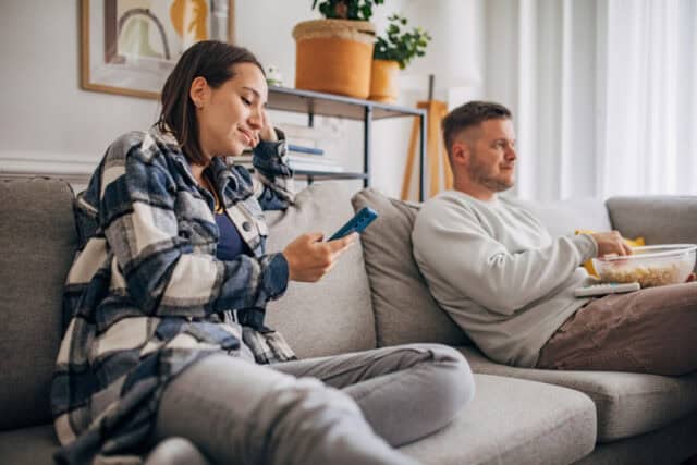 bored couple sitting on couch
