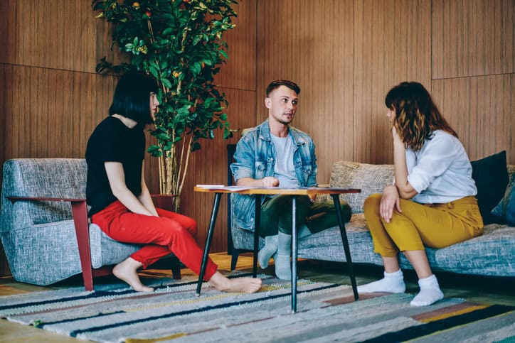 Serious coworkers cooperating for work in room