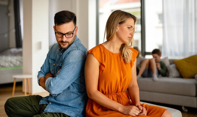 Unhappy couple having argument at home.