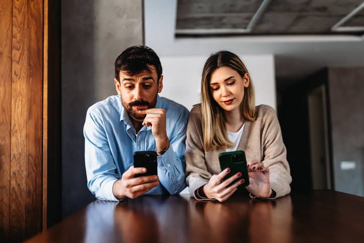 Couple addicted to smartphones ignoring each other at home. Relationship problems