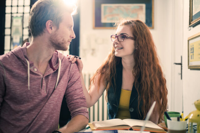 Young ginger students communicating while taking a break from studying.