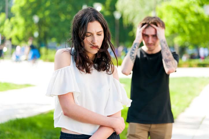 Teenager couple breaking up after argument. The angry boyfriend is rejecting her sad girfriend. The girl in sad