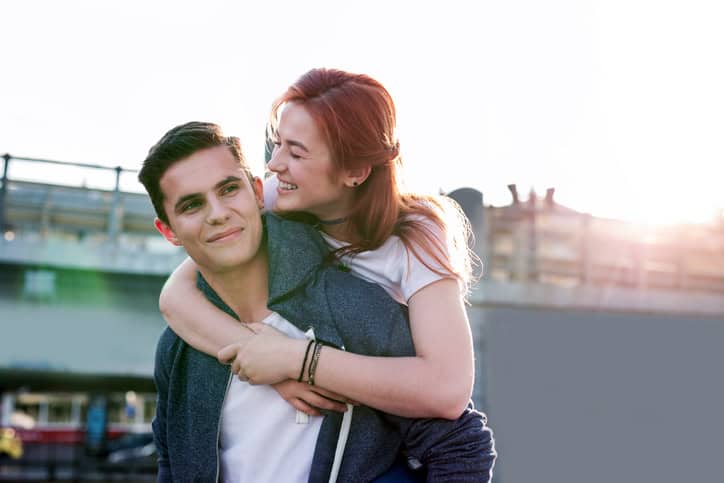 woman on boyfriend's back outdoors