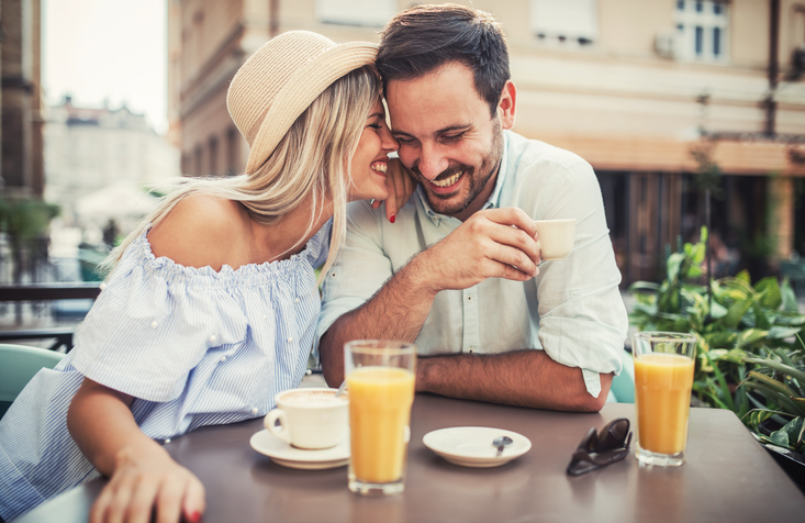 Happy couple eating breakfast.