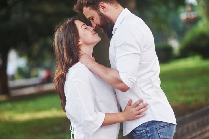 Romantic couple enyojing in moments of happiness in the park. Lifestyle concept love and tenderness