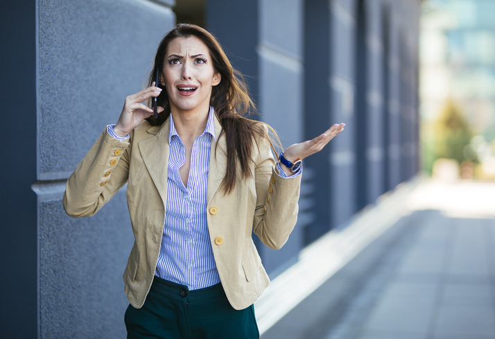 Angry woman talking on her phone.