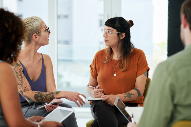 two female colleagues chatting during meeting