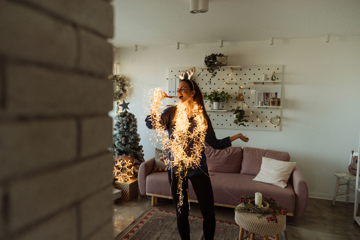 Woman dancing in Christmas garland.