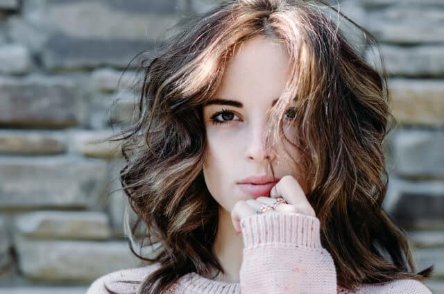 Portrait close-up of beautiful brunette young woman outdoors