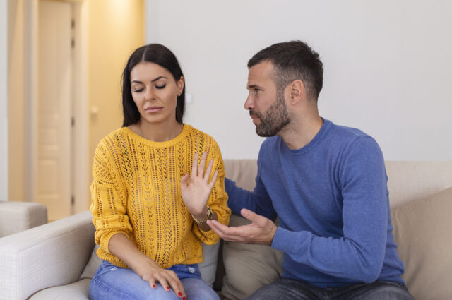 Stressed young man saying sorry after a quarrel with wife.