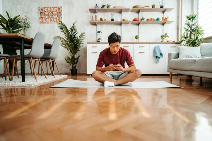 asian man doing yoga on floor