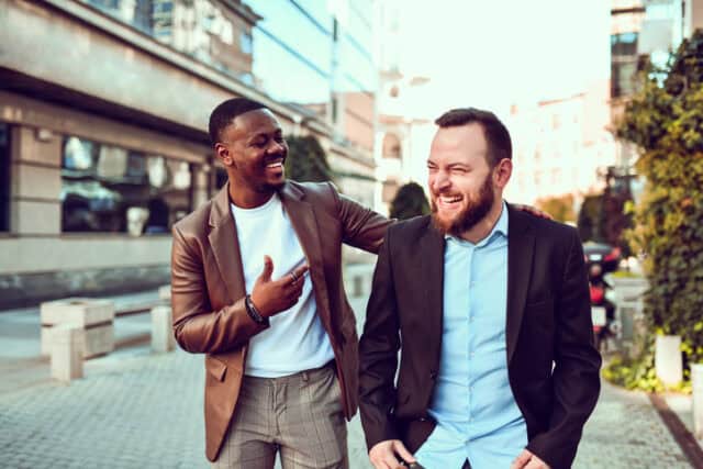 Multiethnic Gay Males Taking A Walk Through City Center And Embracing