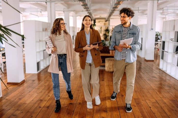 colleages walking and talking in office