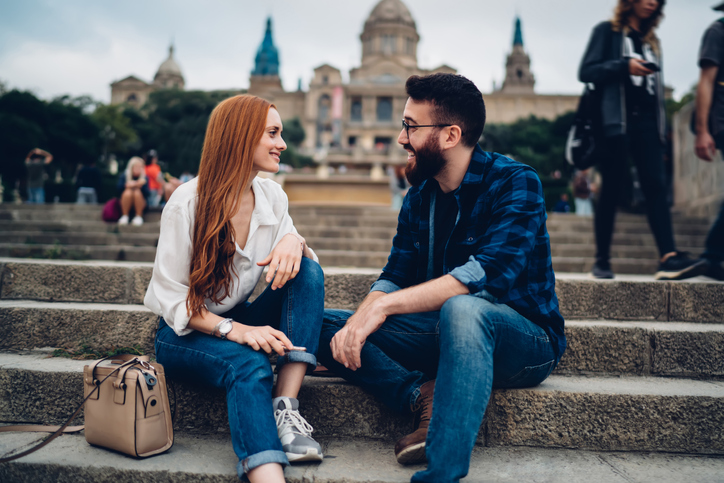 Couple sitting on stairs chatting.