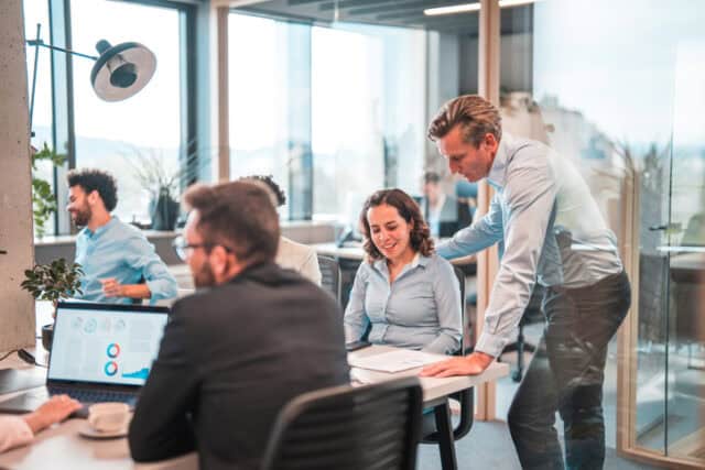 guy giving female colleague pointers