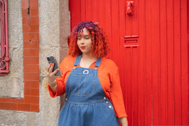 plus-sized woman with phone outside
