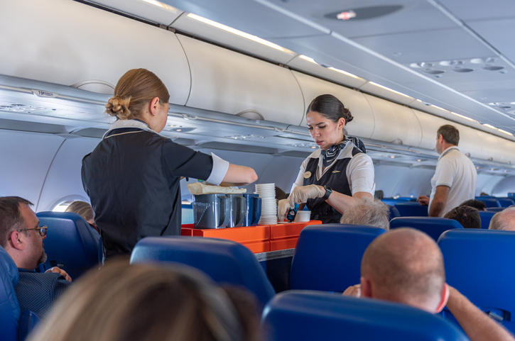 Flight attendants serving coffee.