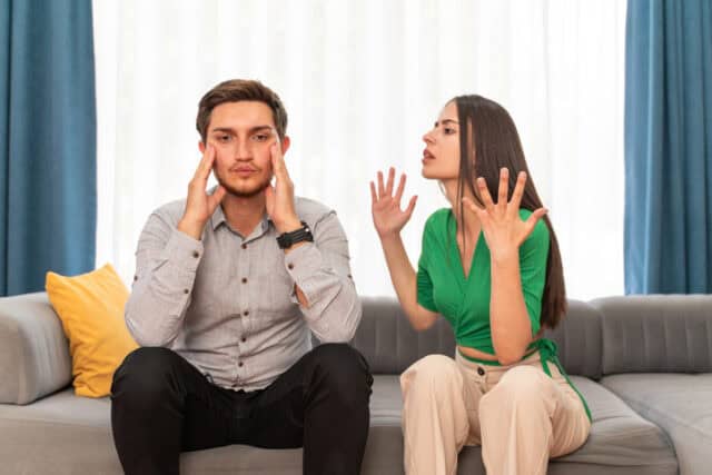 young couple fighting on couch