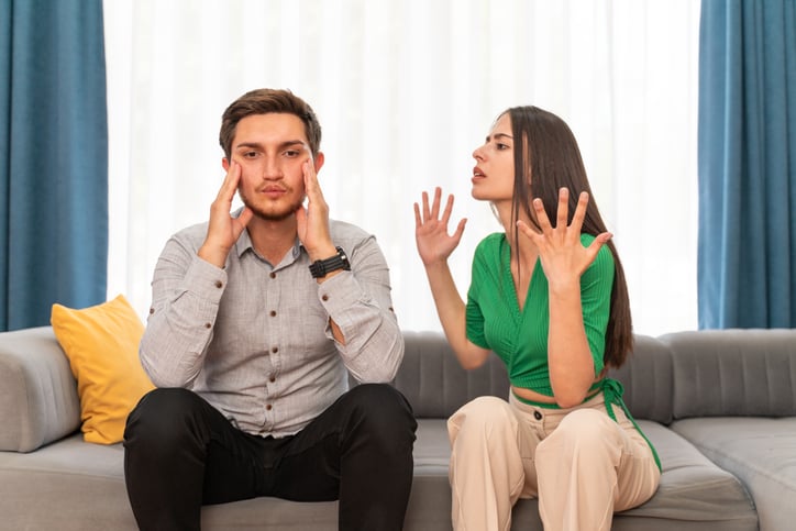 Young couple fighting on couch.