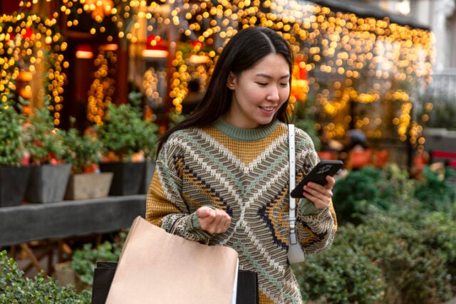 woman reading texts at christmas market