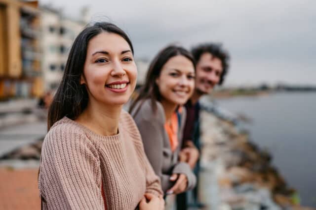 Three friends enjoying the view from the pier in Malmo in Sweden.