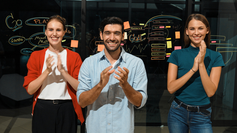 Group of businesspeople celebrate a successful project.