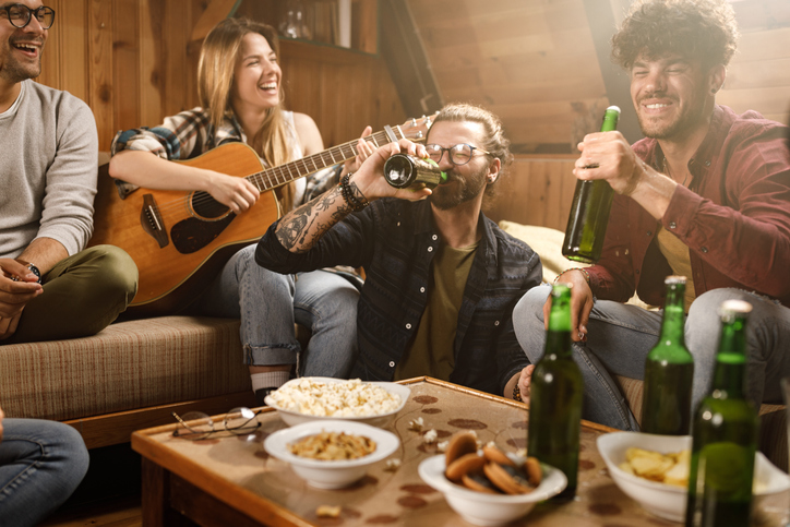 Cheerful friends having fun on social gathering at home.